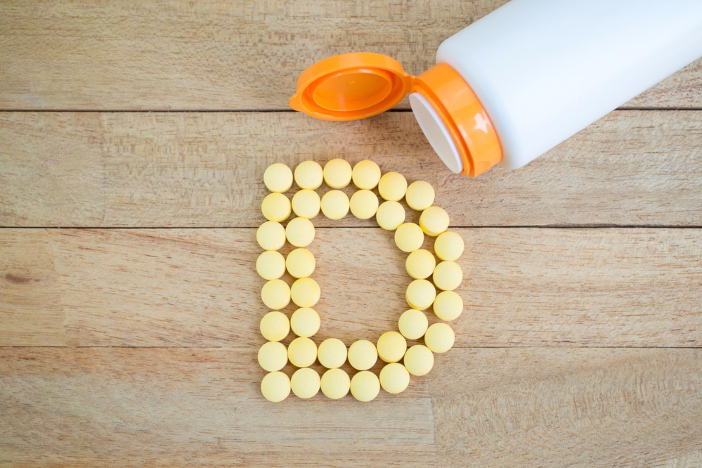 Vitamin D pills arranged in letter D|Couple Smiling And Enjoying Date With Lunch On Building Rooftop|Woman with backache|Female doctor and senior patient discuss medical records|Old Woman's Hands|A pregnant woman holding her baby belly at home