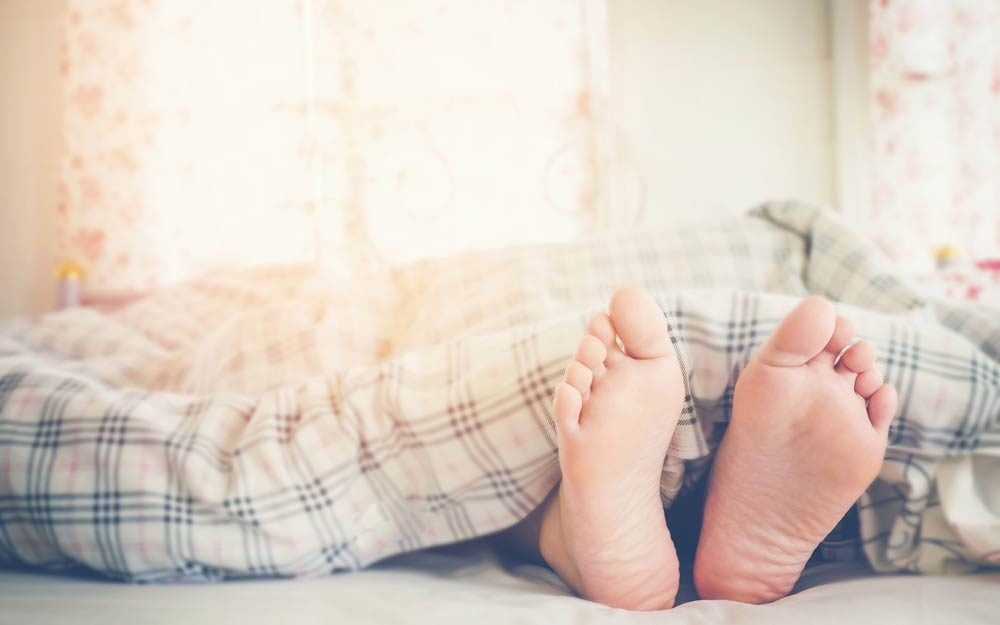 There’s a Scientific Reason Why You Always Sleep Under Blankets—Even When It’s Hot