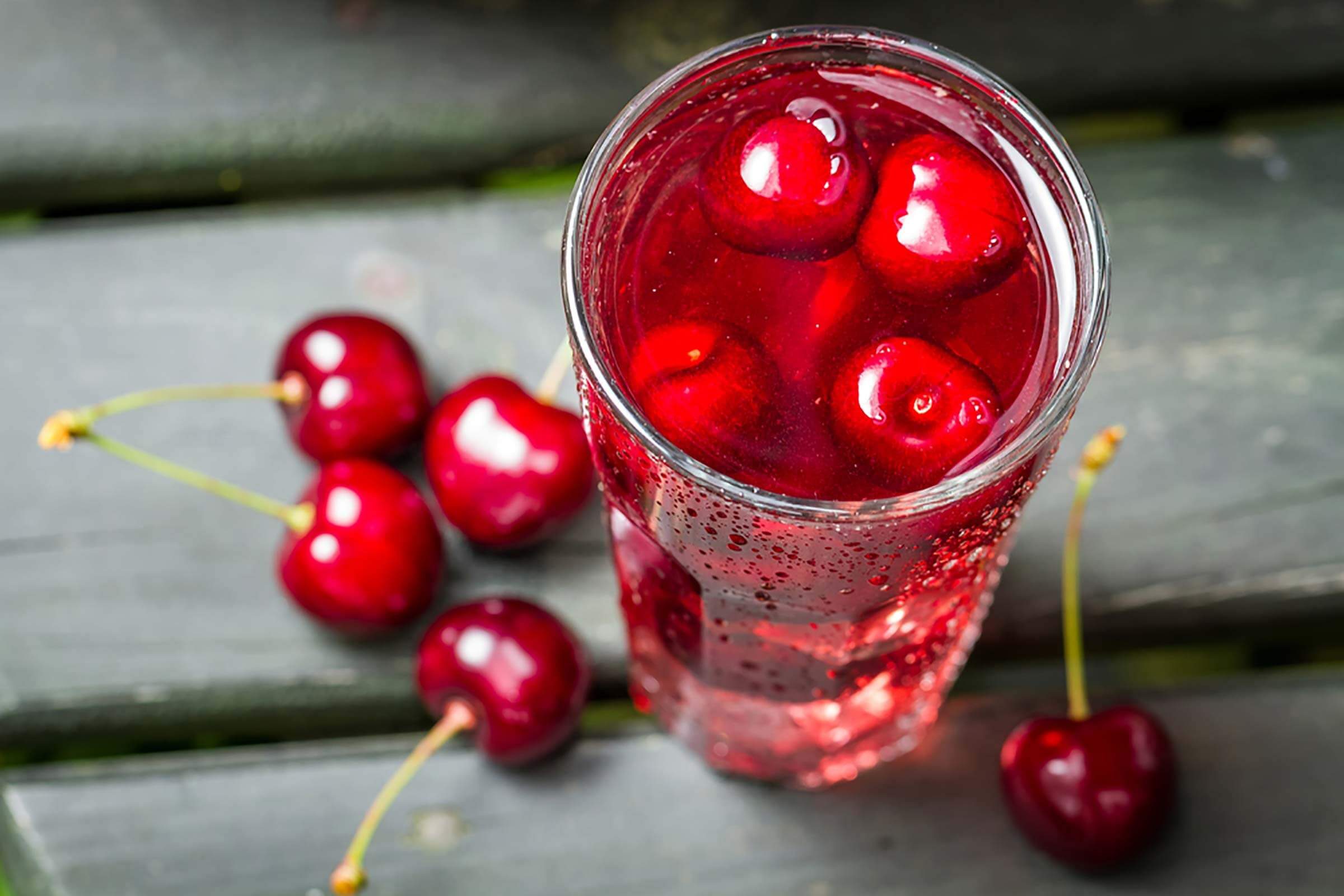 whole cherries on table and with seltzer