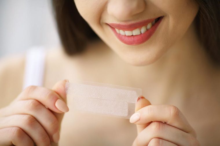 High angle view of female patient being examined by dentist in clinic|High angle view of female patient being examined by dentist in clinic|Teeth-whitening|invisalign|Portrait of a beautiful woman brushing teeth and looking in the mirror in the bathroom.|Pouring mouthwash in glass and space for text on dark background. Teeth care|Teeth Whitening. Beautiful Smiling Woman Holding Whitening Strip. High Resolution Image|gargle|Man hands holding fresh strawberries