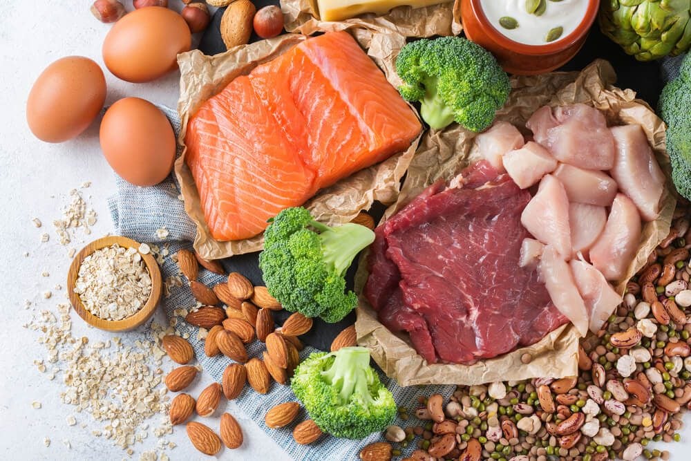 Assortment of healthy protein source and body building food. Meat beef salmon chicken breast eggs dairy products cheese yogurt beans artichokes broccoli nuts oat meal. Top view|Pulses on wooden spoons