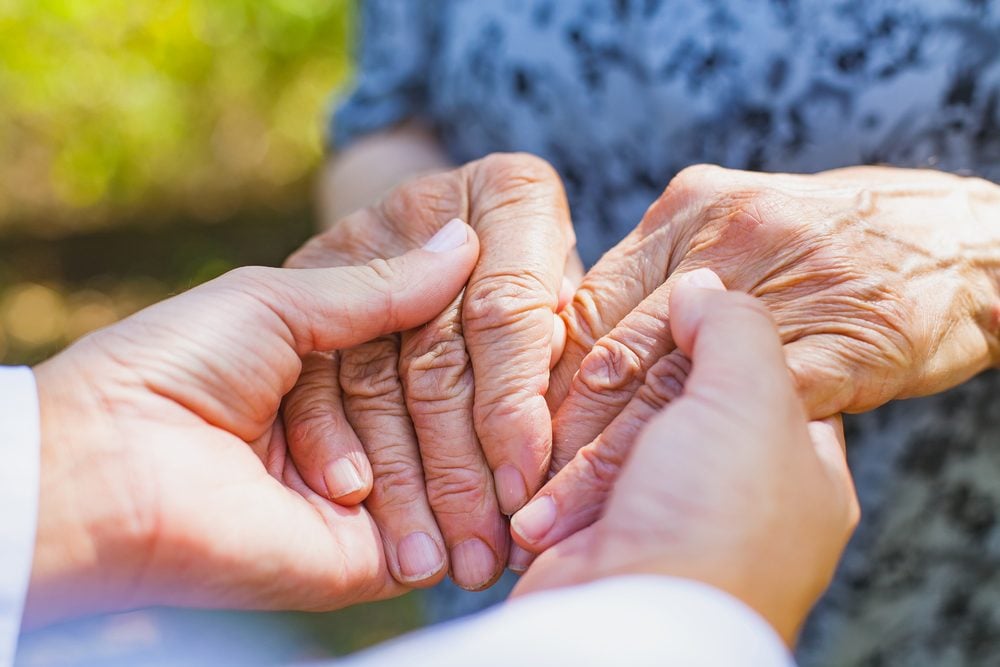 Close up medical doctor holding senior woman's shaking hands, Parkinson disease|Close up medical doctor holding senior woman's shaking hands, Parkinson disease