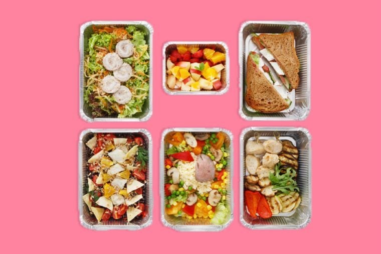 Meals and snacks portioned out in foil containers.