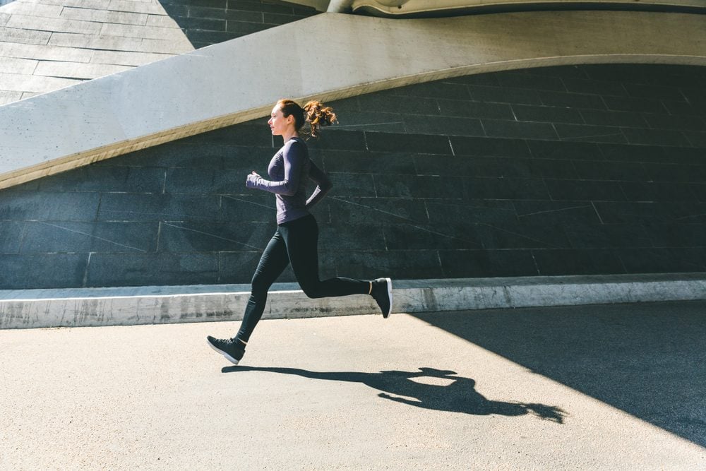 Woman jogging or running, side view with her shadow on the ground. Girl wearing sportswear doing fitness activities outdoors. Healthy lifestyle and sport concepts|Woman jogging or running, side view with her shadow on the ground. Girl wearing sportswear doing fitness activities outdoors. Healthy lifestyle and sport concepts