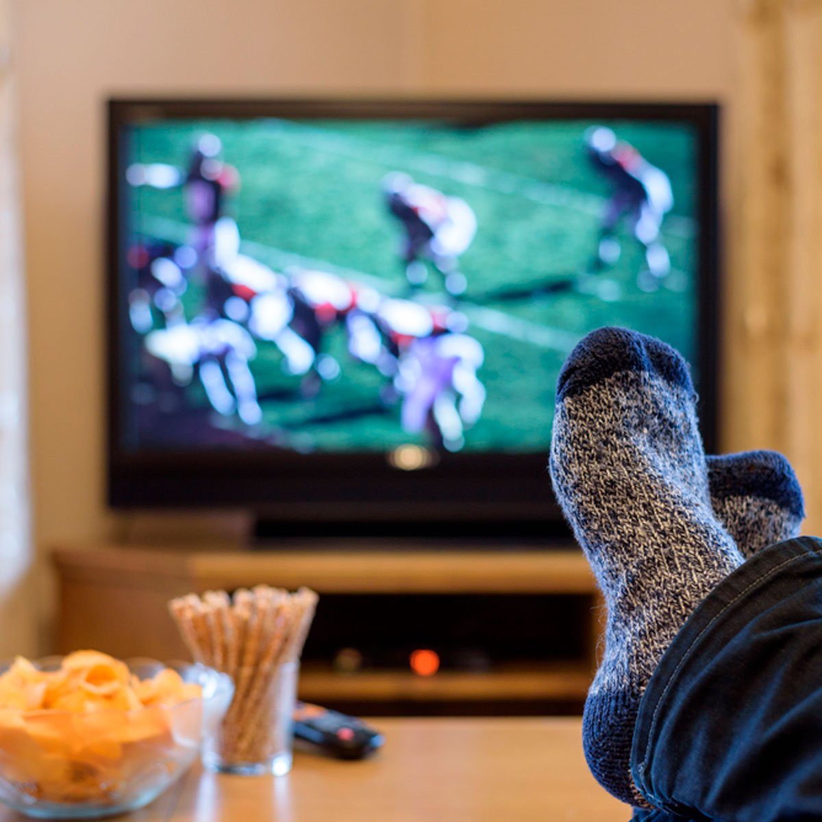 watching tv|woman at gym on exercise machine