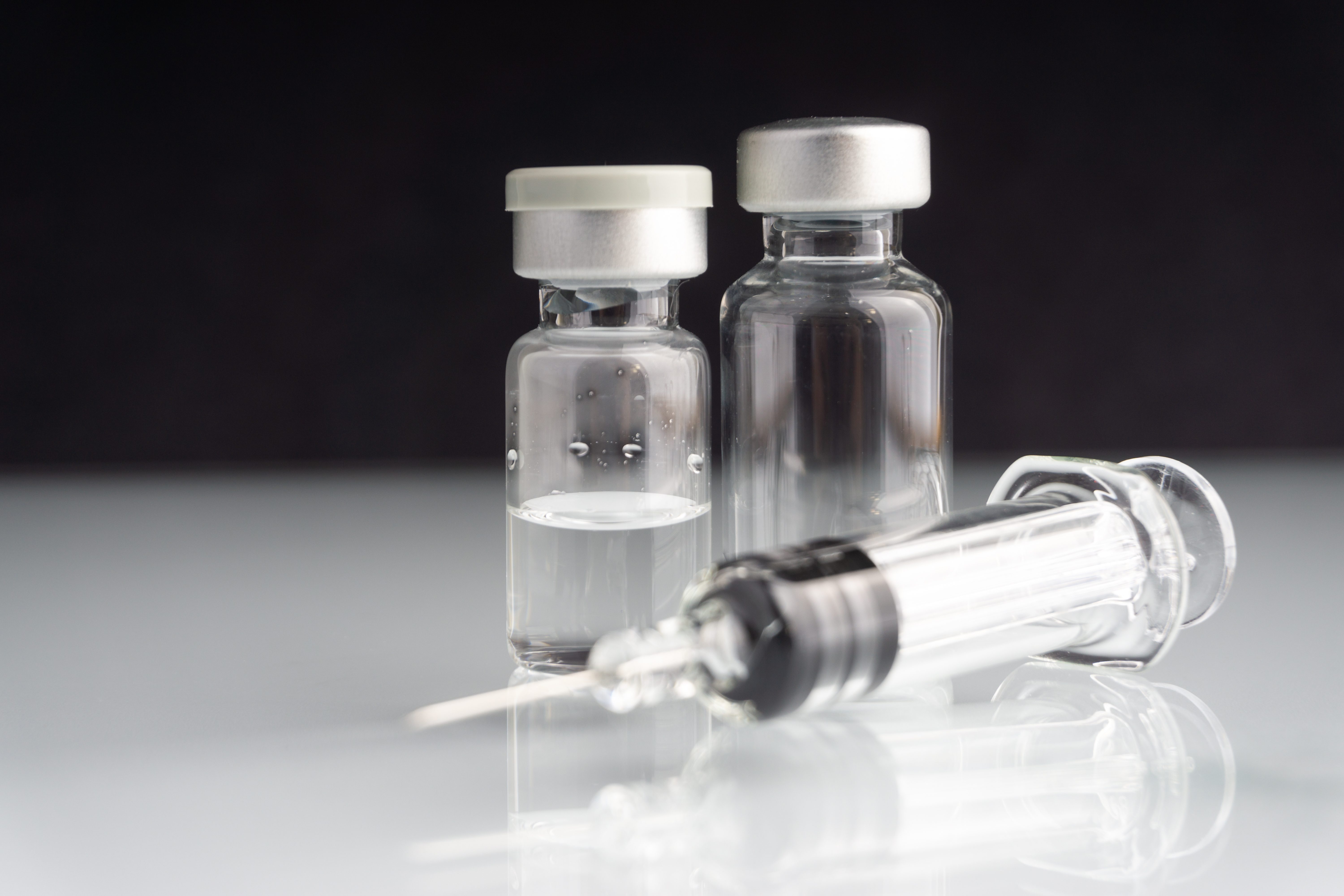 Syringe and vials closeup with selective focus and crop fragment. Medical and Healthcare Concept