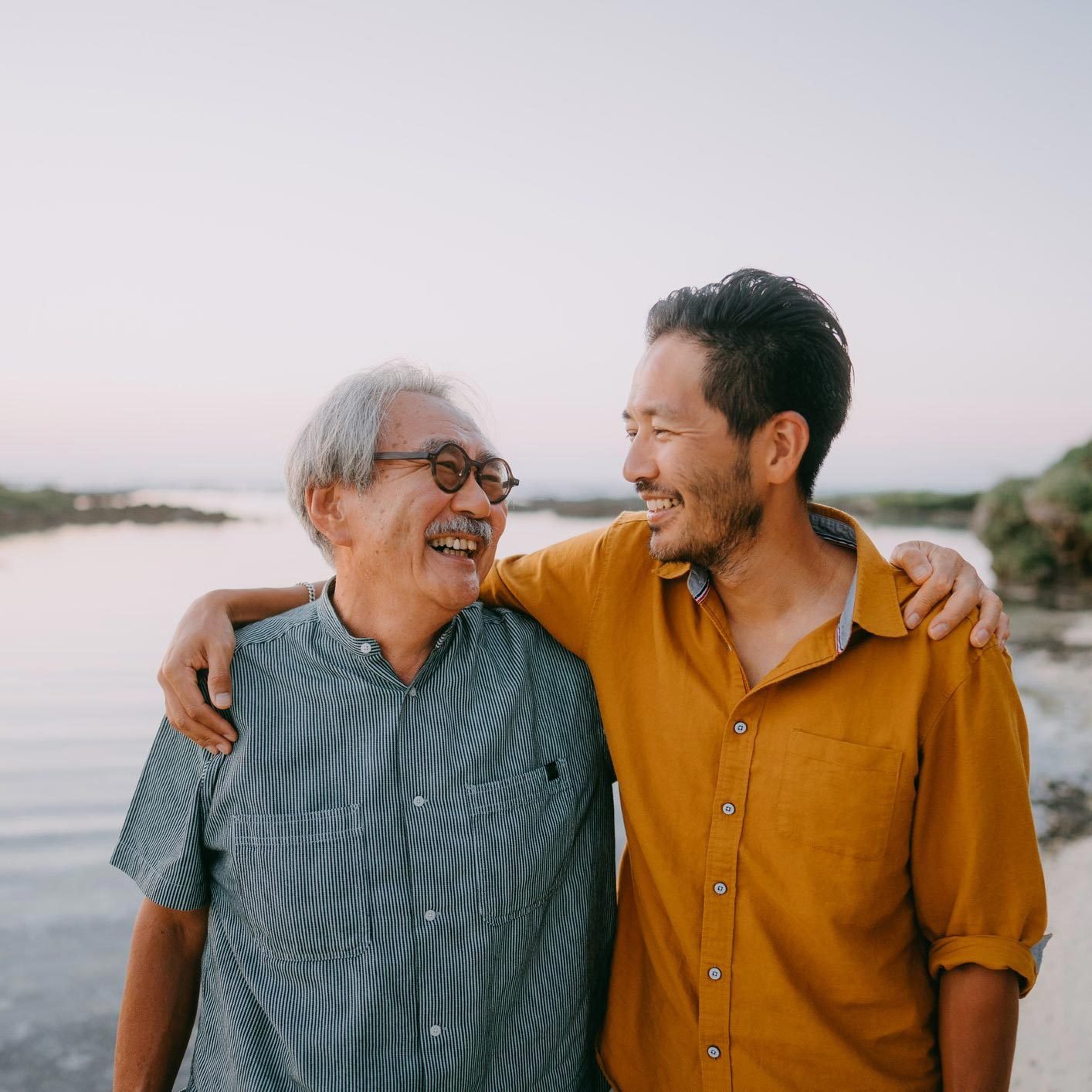 man and his father smiling while walking