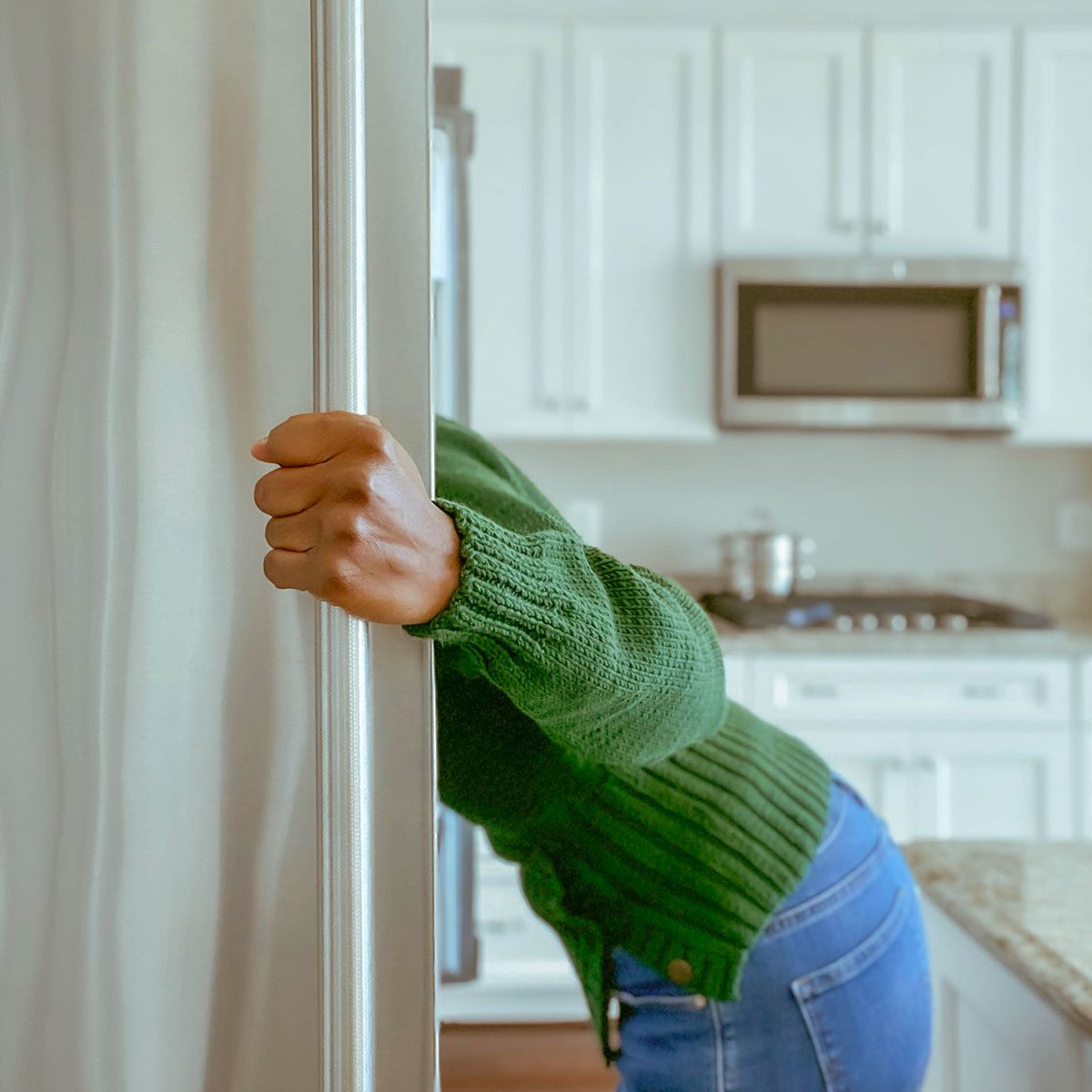 Lady looking into fridge|