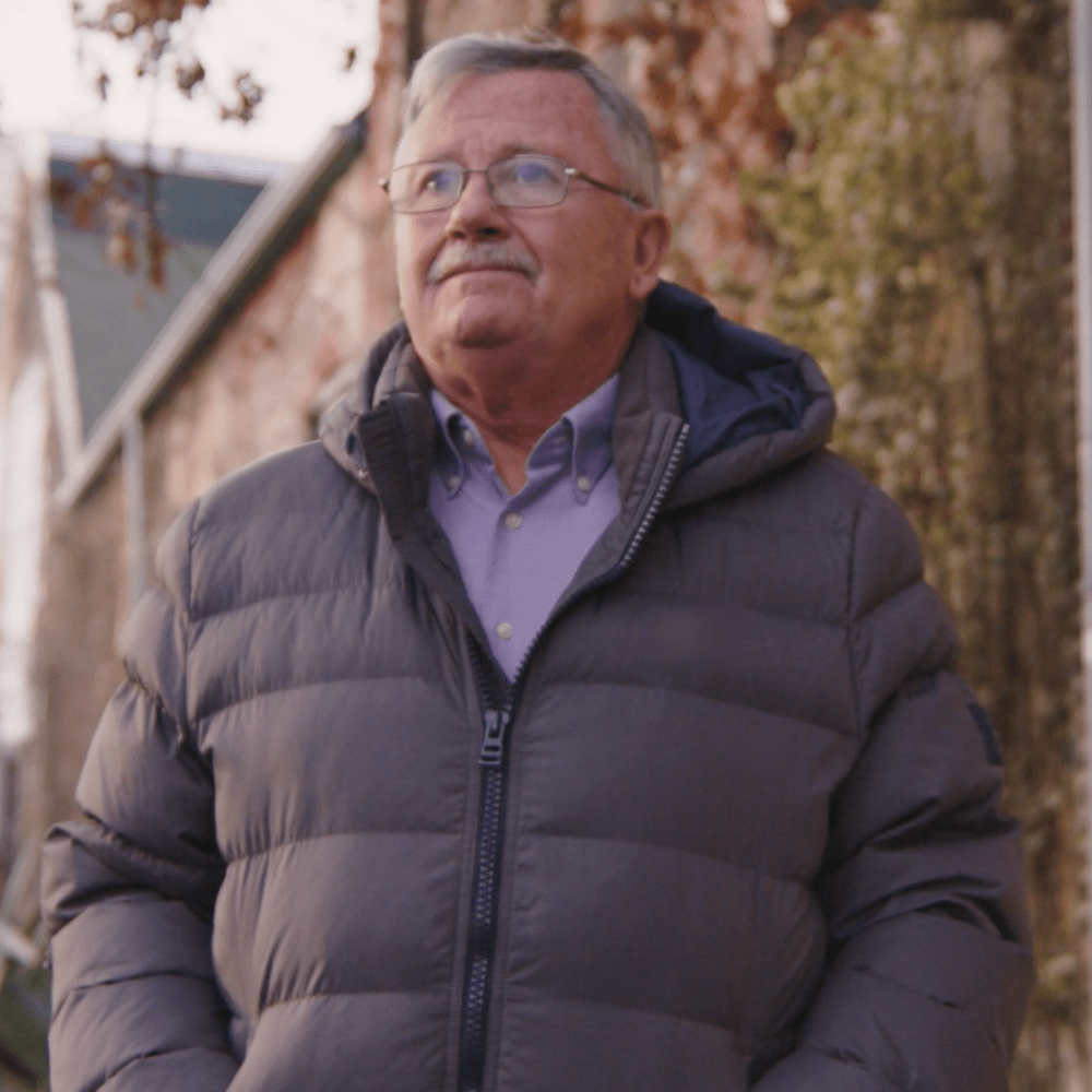 man in winter coat smiling