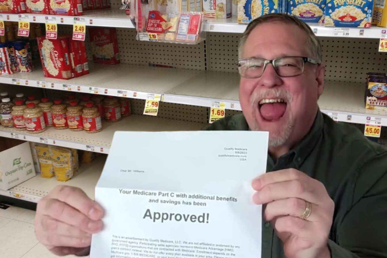 man holds paper showing he is approved