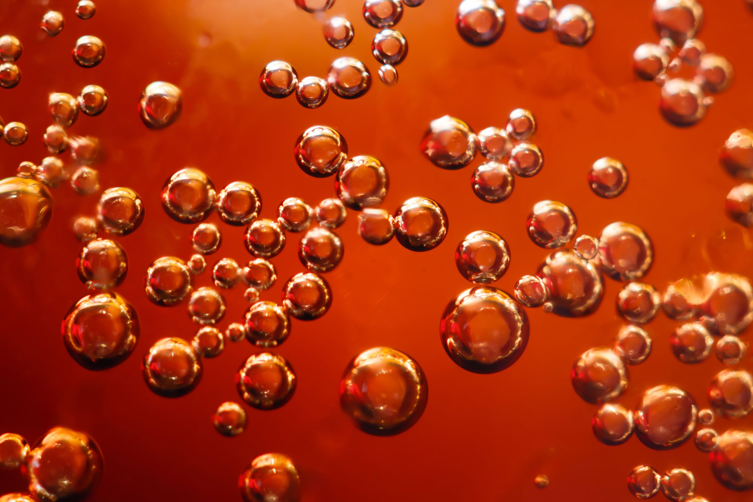 fizzy orange beer bubbles close up
