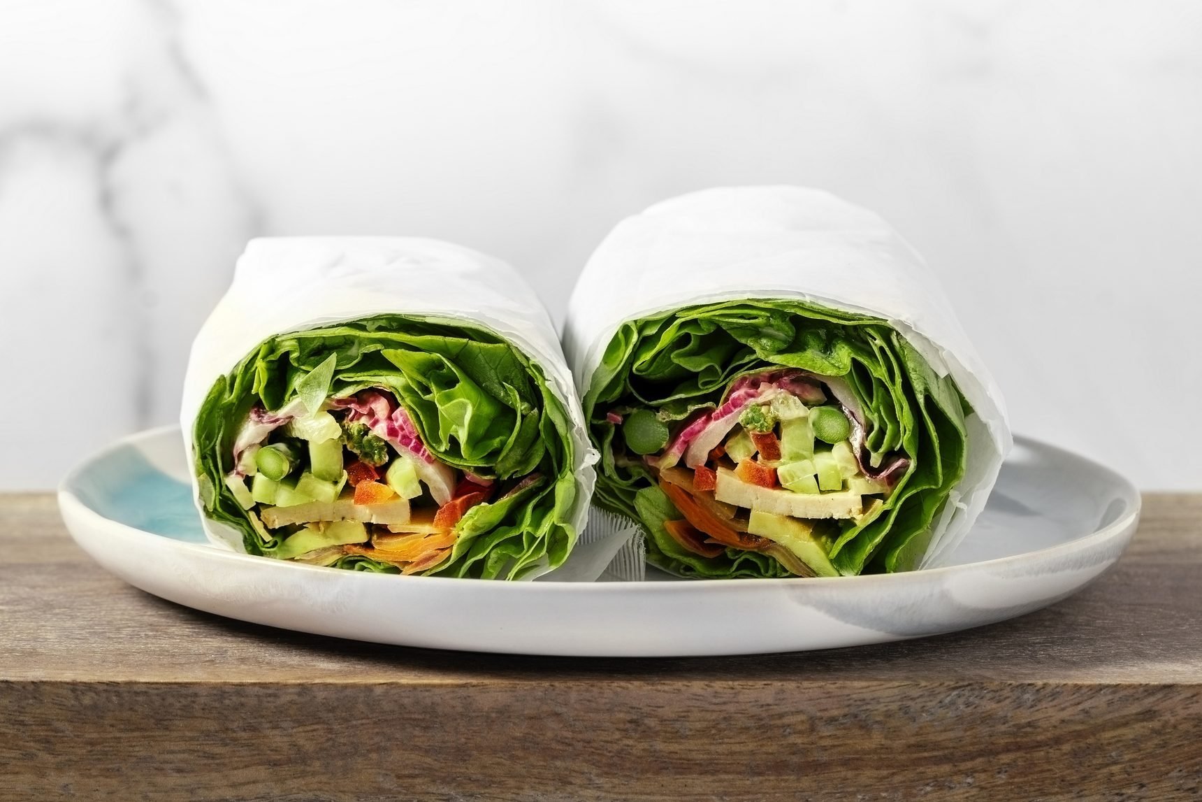 Healthy vegan wraps on a plate on white background