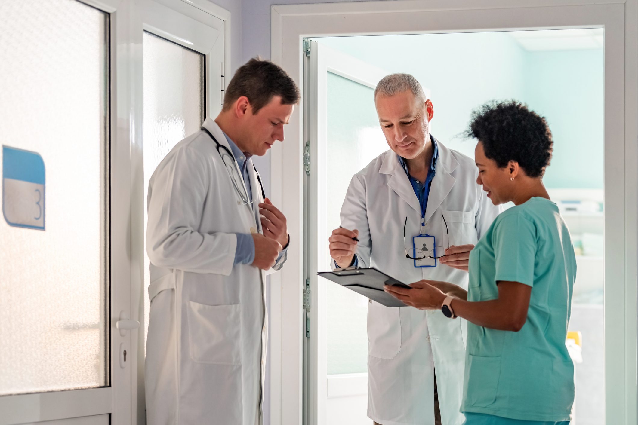 A doctor filling in a medical insurance form or signing a contract agreement.