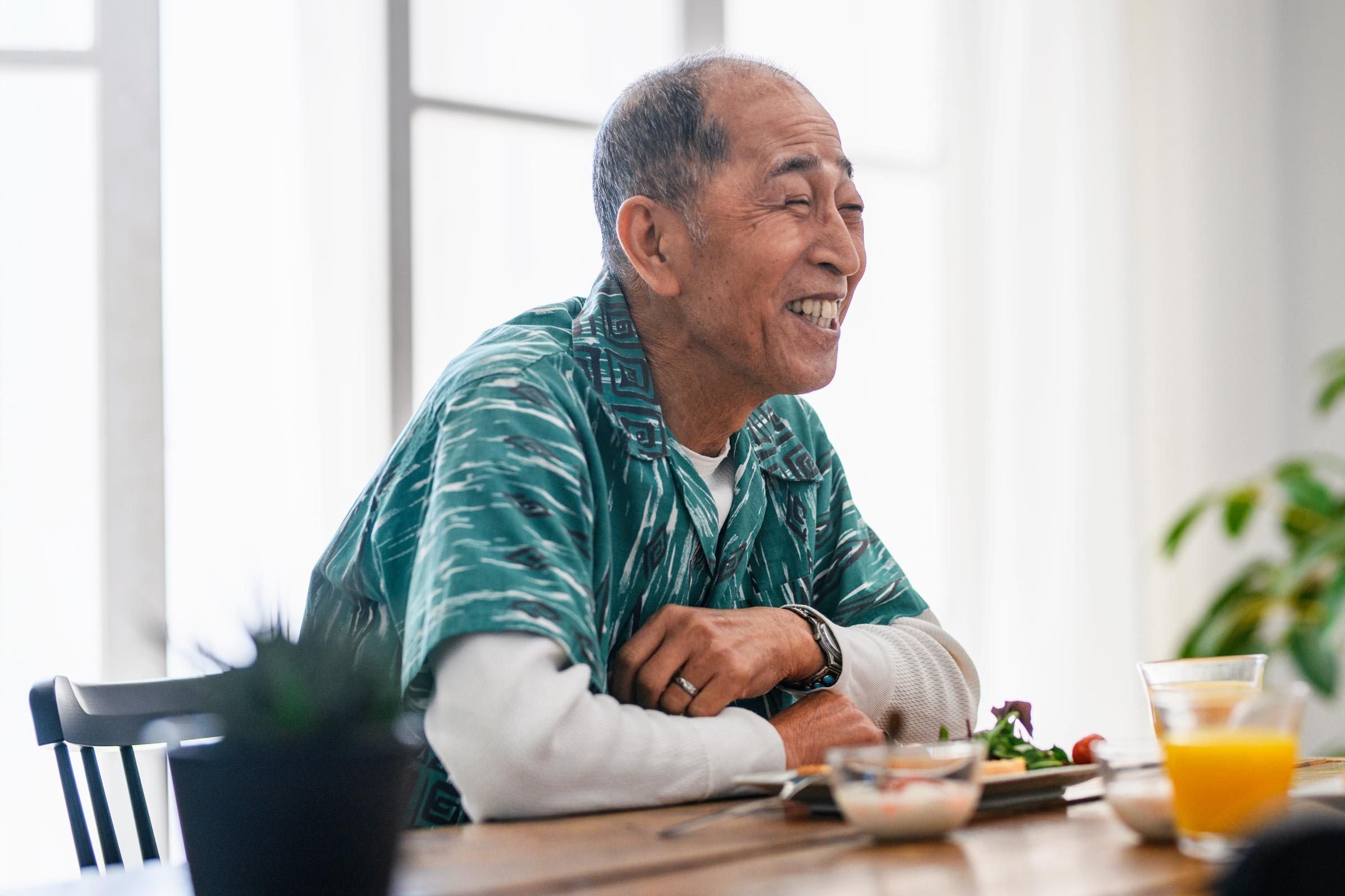happy older Japanese man at the breakfast table