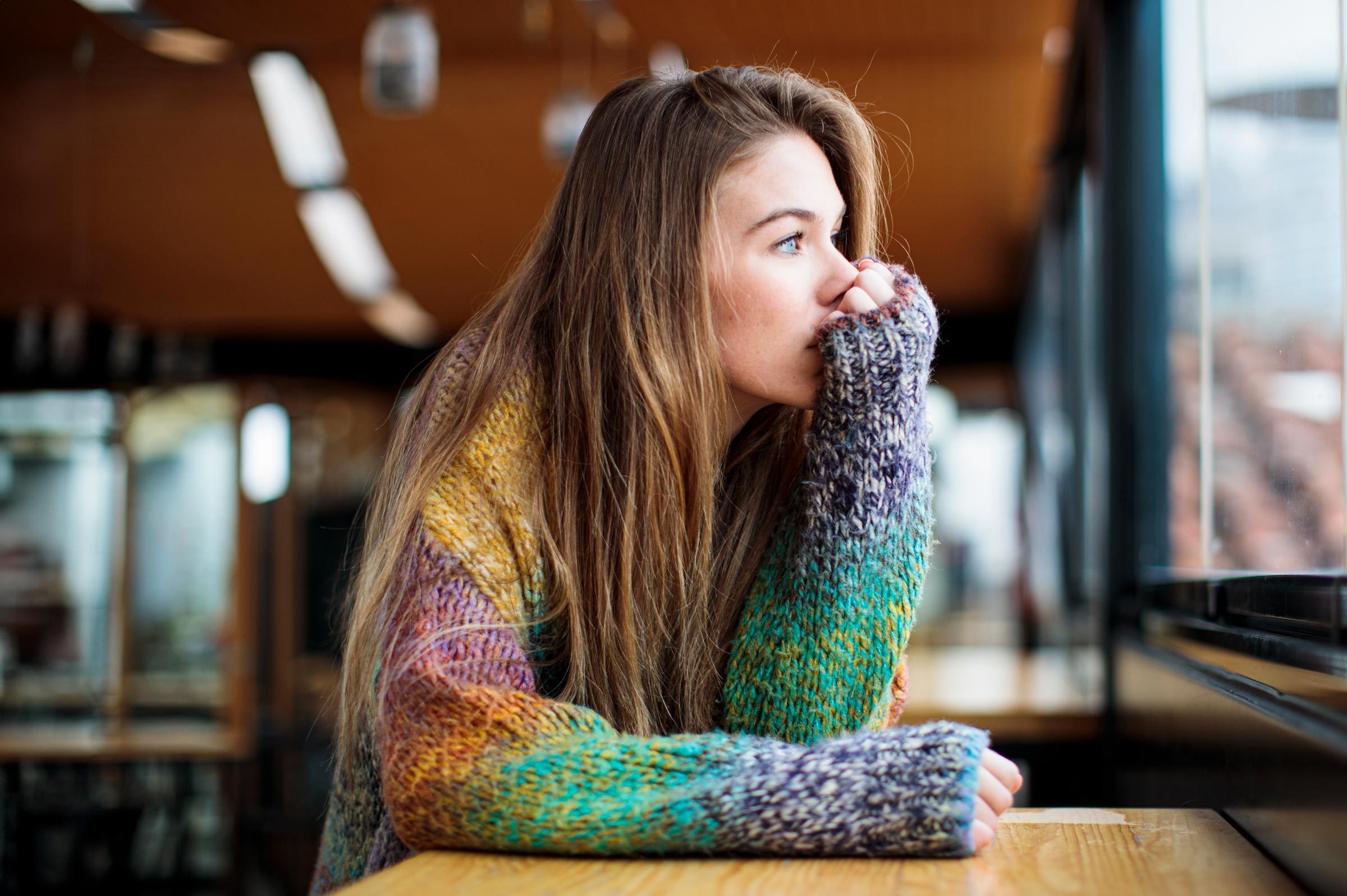 Depressed anxious girl looking out the window