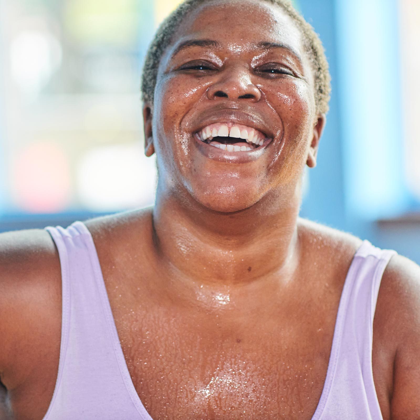 smiling woman sweating while exercising