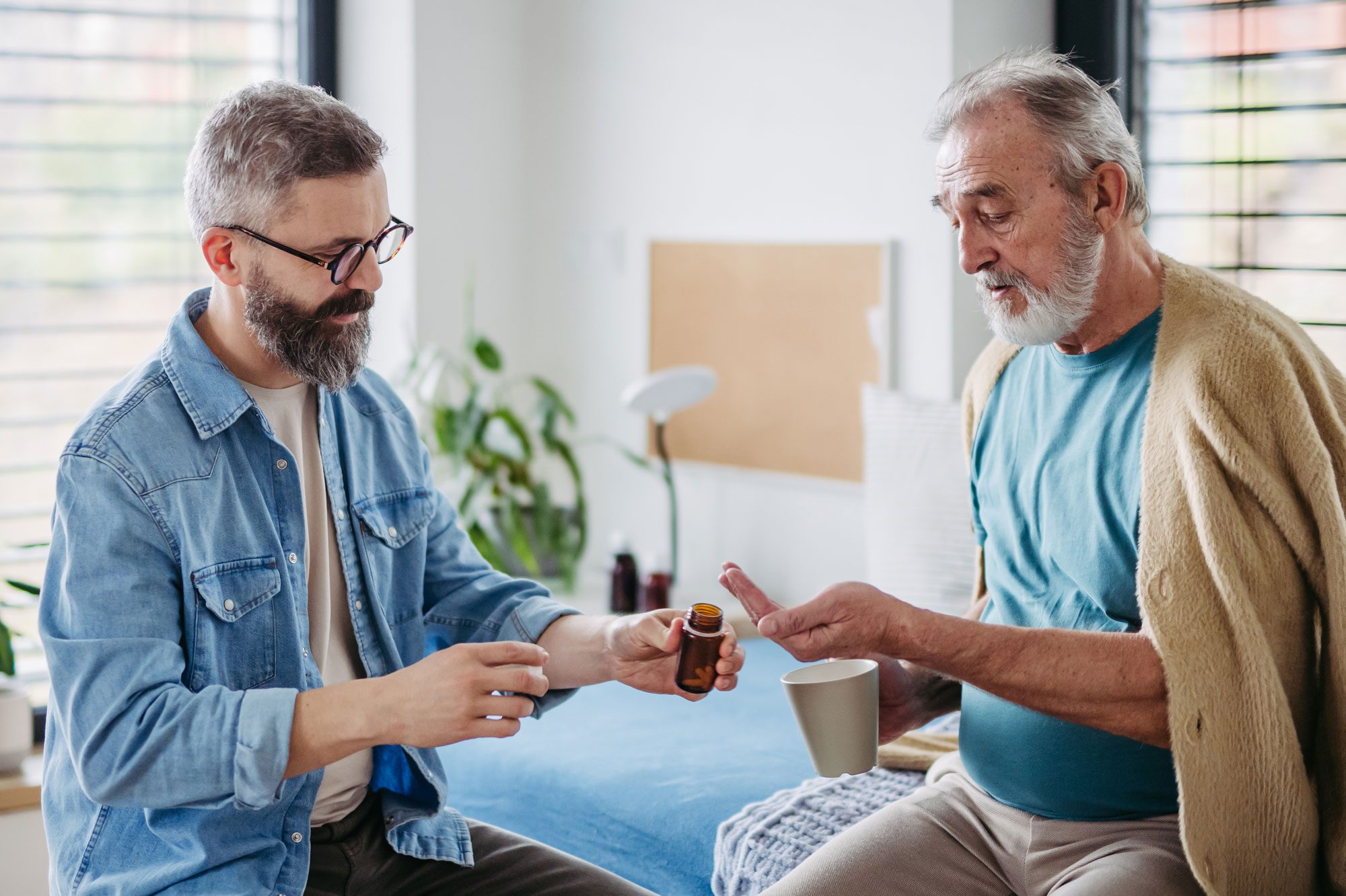 Son Giving Elderly Fathers Prescribed Medication