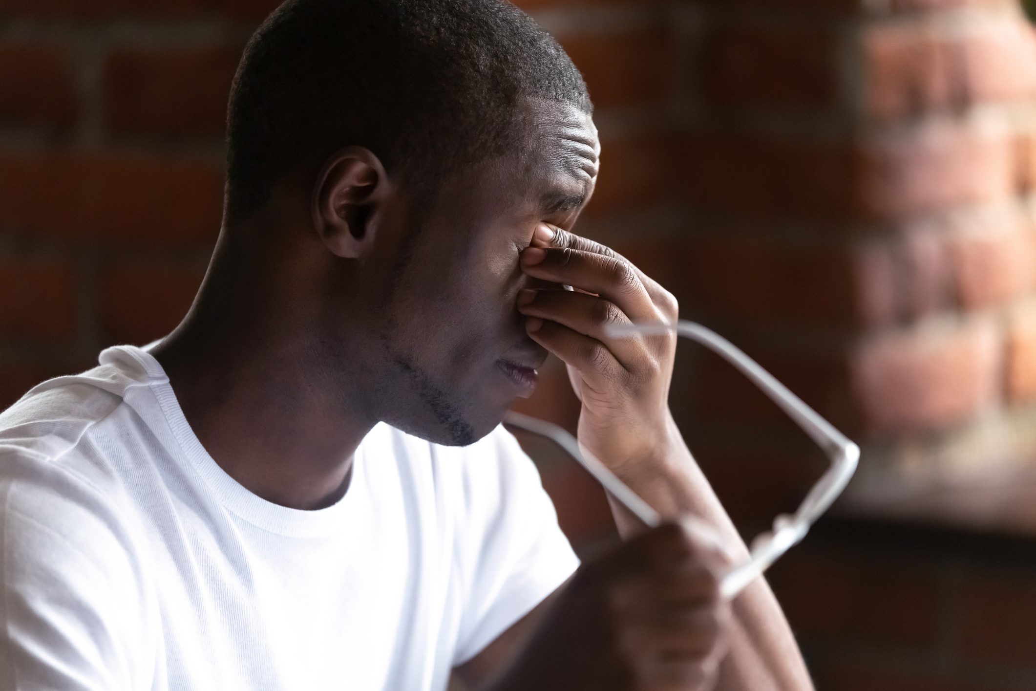 Close up black students take off glasses massaging eyes